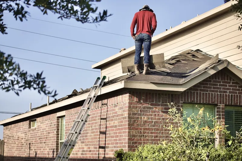 Professional roofer working on a residential roof in Leimert Park